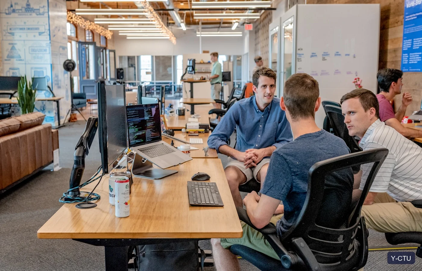 Software team reviewing quality assurance findings around a table.