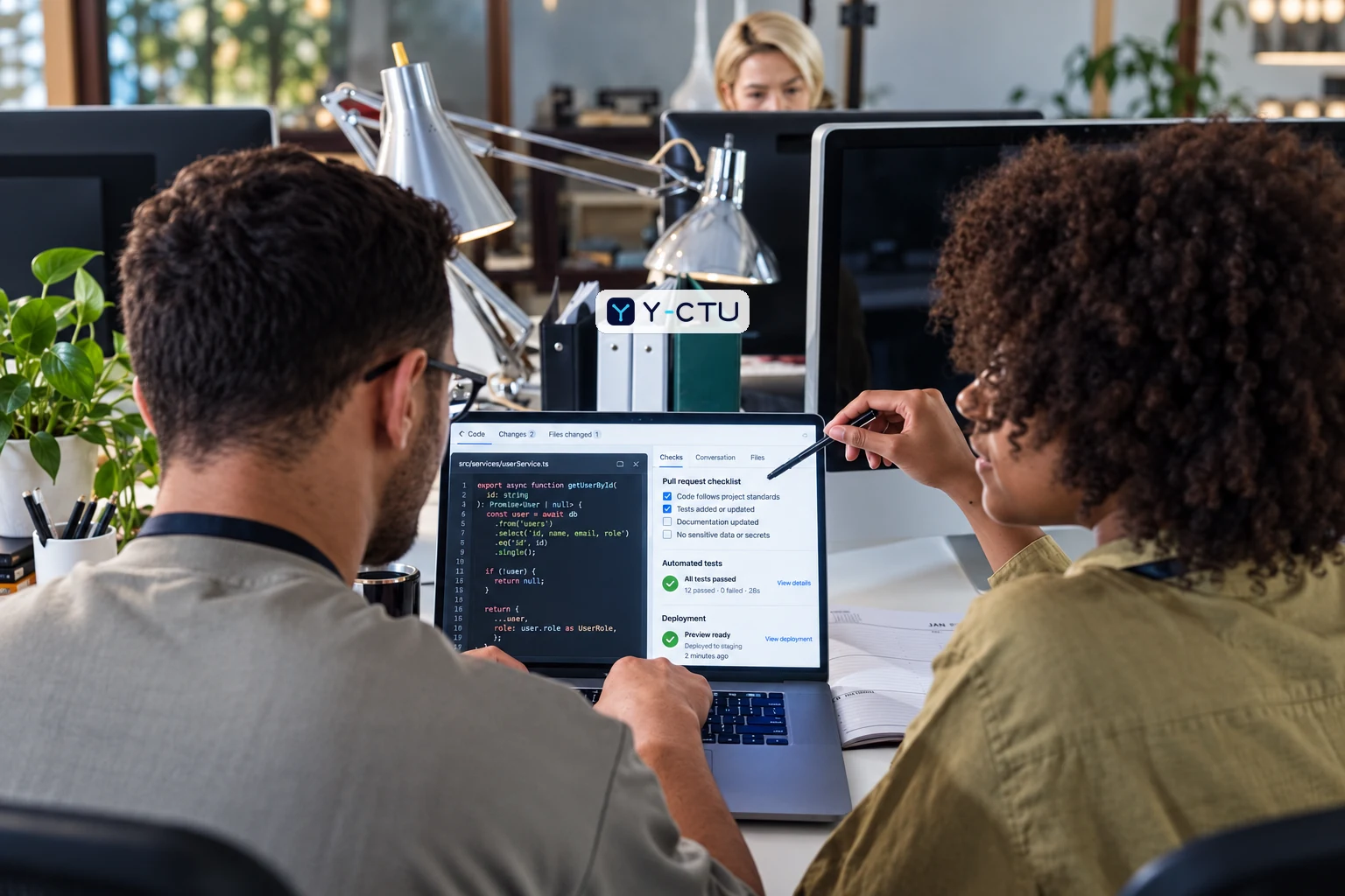 Software engineers conducting a code review with automated tests and deployment checks